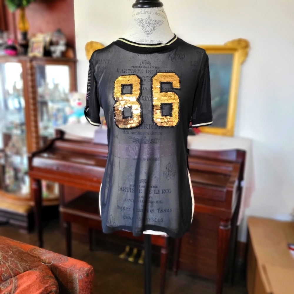 Sheer black jersey with gold sequined numbers